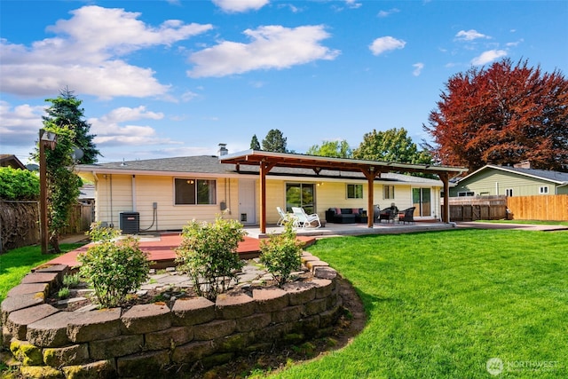 rear view of property with a fenced backyard, a wooden deck, central AC unit, and a lawn