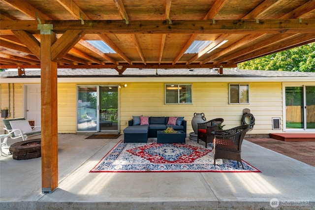 view of patio featuring an outdoor living space with a fire pit