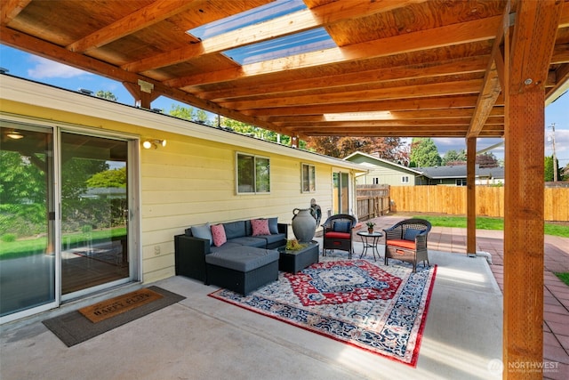 view of patio featuring an outdoor hangout area and fence