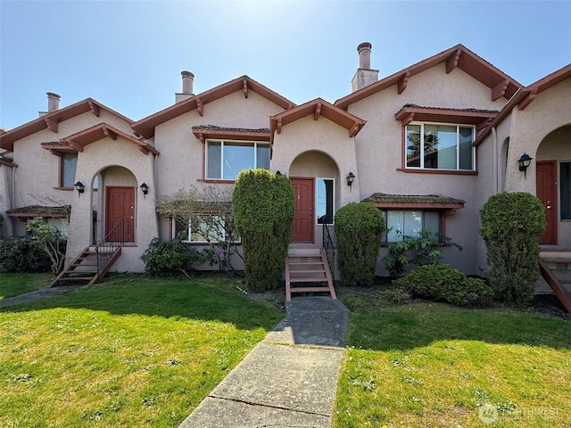 mediterranean / spanish-style house featuring stucco siding and a front yard