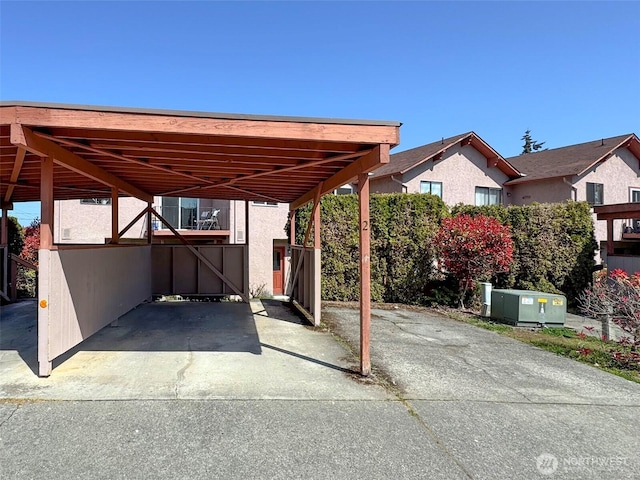 view of patio / terrace featuring a carport and concrete driveway
