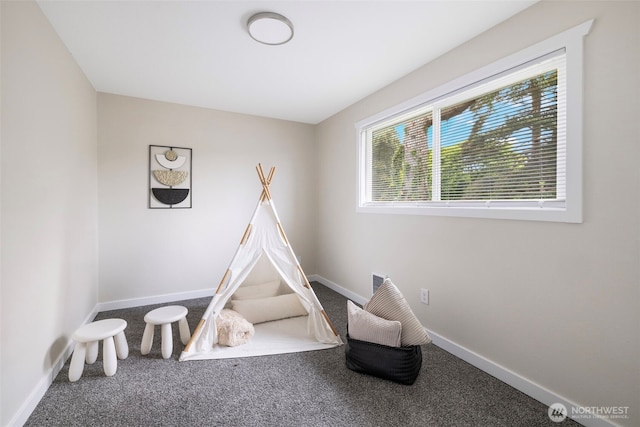 recreation room featuring carpet floors and baseboards