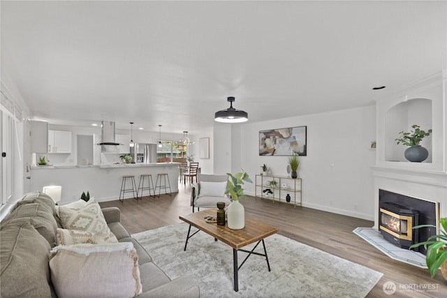 living area with wood finished floors and baseboards