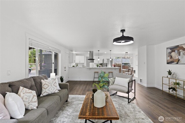 living area with dark wood finished floors and baseboards