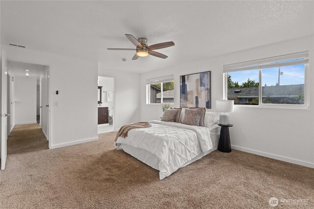 bedroom with carpet floors, multiple windows, baseboards, and ceiling fan
