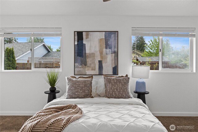 bedroom with carpet floors and baseboards