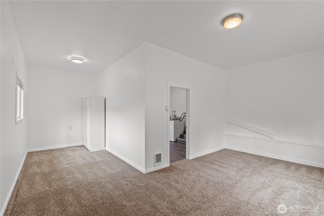 unfurnished room with carpet flooring and baseboards