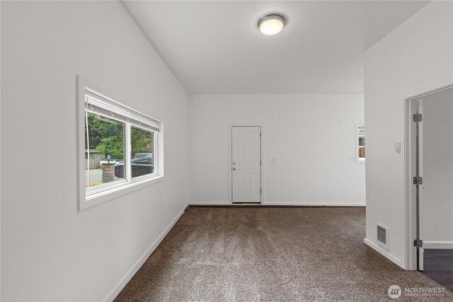carpeted empty room with baseboards