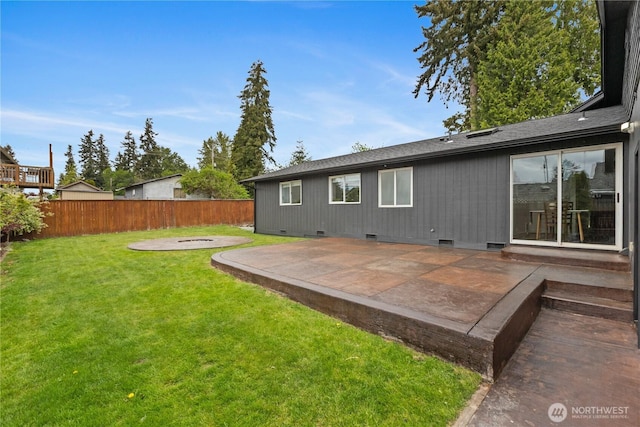 rear view of property featuring a patio area, crawl space, and a shingled roof