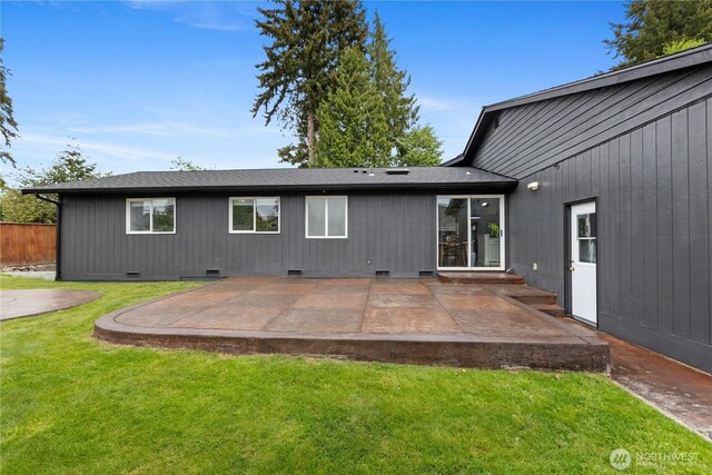 back of property with crawl space, a lawn, a patio area, and roof with shingles