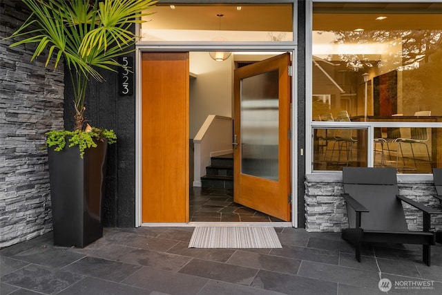 property entrance featuring stone siding