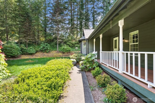 view of yard with covered porch