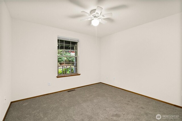 empty room featuring carpet floors, a ceiling fan, baseboards, and visible vents