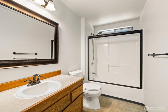 bathroom featuring vanity, toilet, and shower / bath combination with glass door