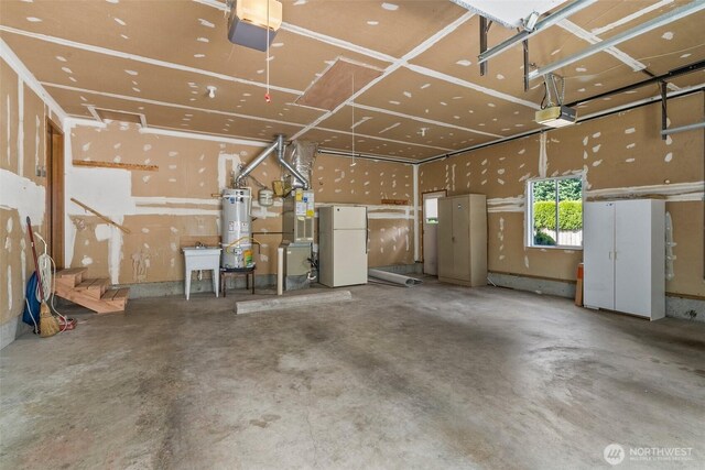 garage featuring freestanding refrigerator, a sink, a garage door opener, and water heater