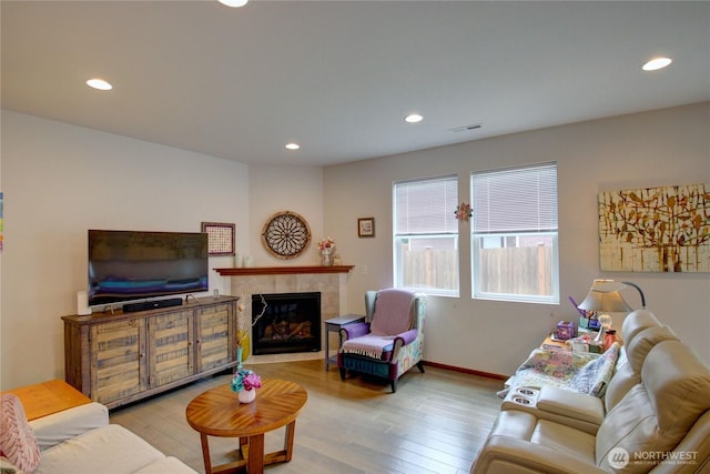 454 S 48th St, Mount Vernon, WA 98274 - living room featuring recessed lighting, light wood finished floors, and a tiled fireplace