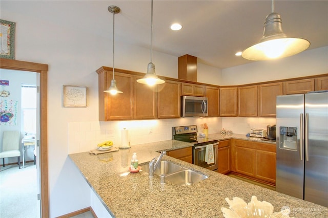 454 S 48th St, Mount Vernon, WA 98274 - kitchen with appliances with stainless steel finishes, brown cabinetry, a sink, and light stone counters