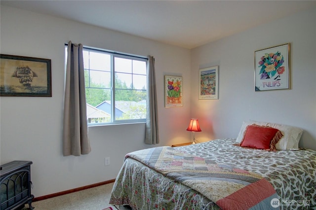454 S 48th St, Mount Vernon, WA 98274 - bedroom with baseboards, carpet, and a wood stove