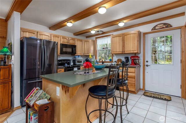 121 Sunstone Rd, Packwood, WA 98361 - kitchen with dark countertops, a kitchen breakfast bar, black appliances, and light tile patterned flooring