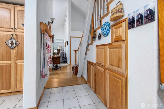 121 Sunstone Rd, Packwood, WA 98361 - corridor with light tile patterned floors, stairs, and lofted ceiling