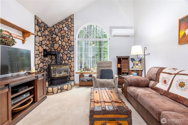 121 Sunstone Rd, Packwood, WA 98361 - living area featuring carpet floors, an AC wall unit, high vaulted ceiling, and a wood stove