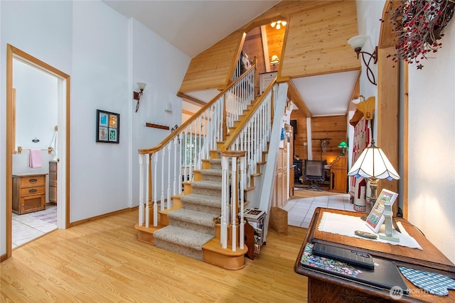 121 Sunstone Rd, Packwood, WA 98361 - staircase with wooden walls, a high ceiling, and wood finished floors