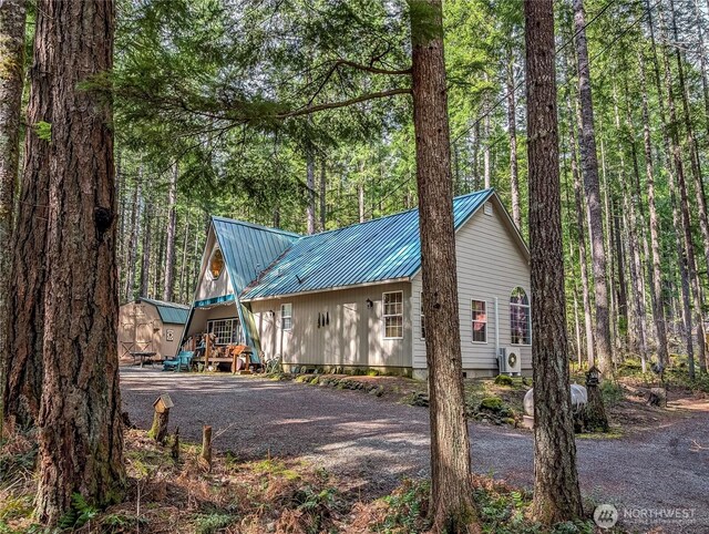 121 Sunstone Rd, Packwood, WA 98361 - exterior space with metal roof, a storage shed, ac unit, an outbuilding, and aphalt driveway