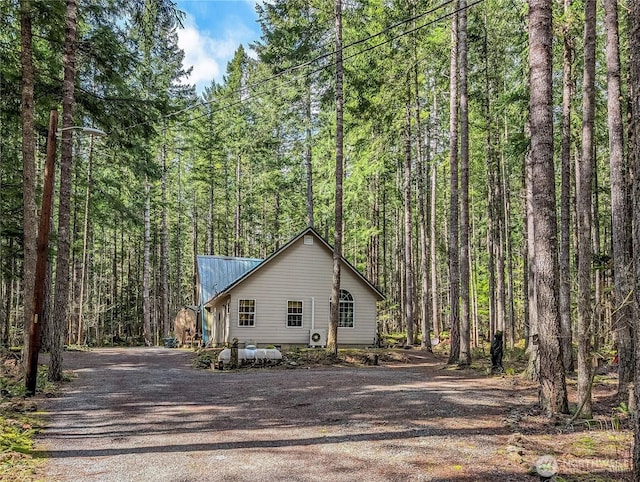 121 Sunstone Rd, Packwood, WA 98361 - view of side of property featuring dirt driveway, metal roof, and a forest view