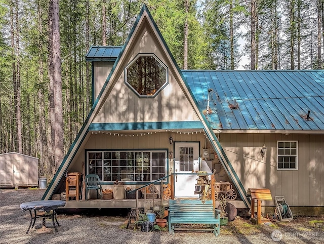 121 Sunstone Rd, Packwood, WA 98361 - rear view of property featuring a standing seam roof, a shed, an outbuilding, and metal roof