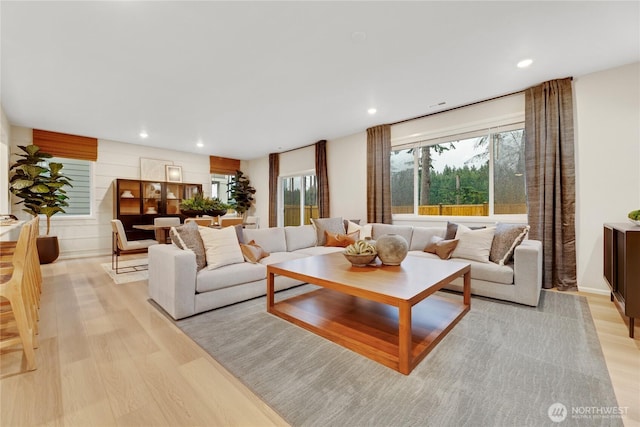 living area featuring light wood-type flooring, recessed lighting, and plenty of natural light