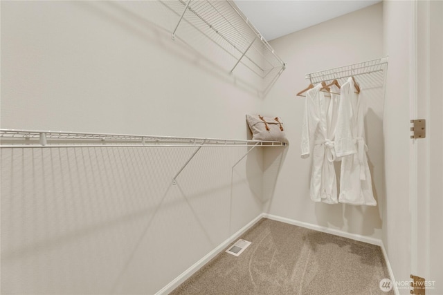 walk in closet with carpet floors and visible vents