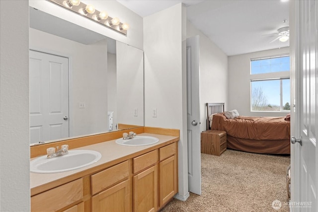 ensuite bathroom with a sink, ensuite bathroom, a ceiling fan, and double vanity