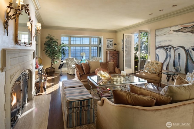 living room with ornamental molding, wood finished floors, and a premium fireplace