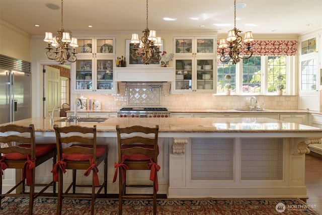 kitchen featuring an inviting chandelier and a sink