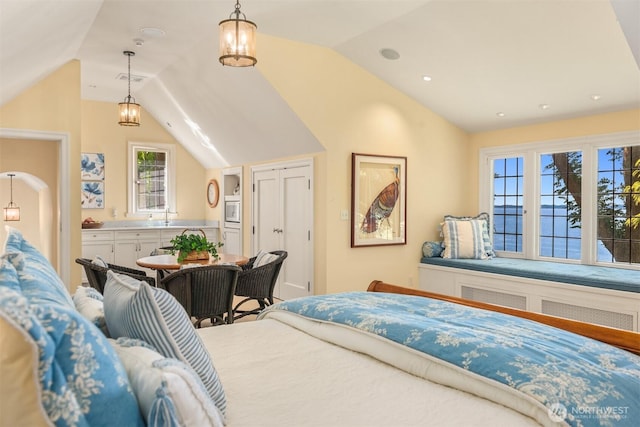 bedroom featuring vaulted ceiling and visible vents
