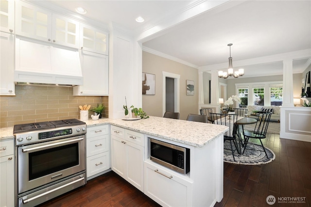 kitchen featuring crown molding, stainless steel appliances, white cabinets, and a peninsula