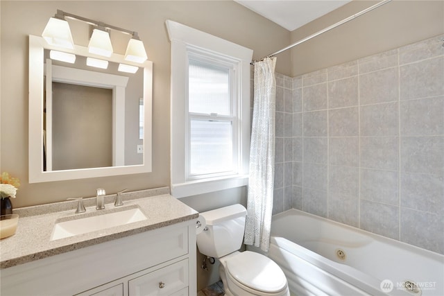 bathroom featuring toilet, shower / tub combo with curtain, and vanity
