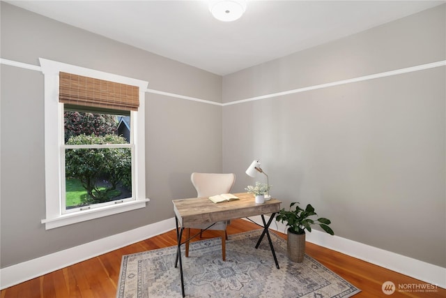 office area featuring baseboards and wood finished floors
