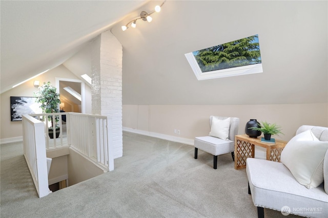living area with vaulted ceiling with skylight, carpet floors, baseboards, and an upstairs landing