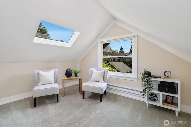 sitting room with a baseboard heating unit, lofted ceiling with skylight, and carpet flooring