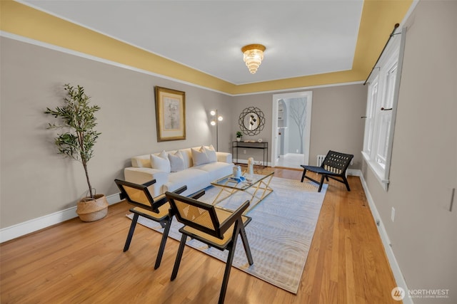 living area with baseboards and light wood-type flooring