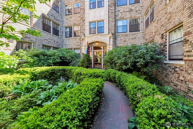 entrance to property featuring brick siding