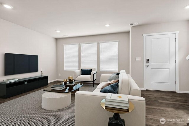 living area featuring visible vents, recessed lighting, dark wood-style flooring, and baseboards
