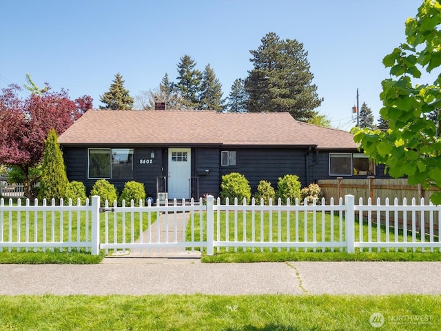 ranch-style home with a chimney and roof with shingles