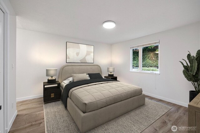 bedroom featuring baseboards and wood finished floors