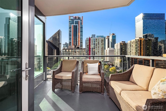 balcony featuring a city view and an outdoor living space