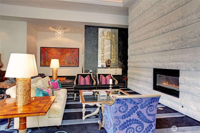 living room with a glass covered fireplace and ornamental molding