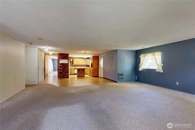 1557 Shelton Rd, Walla Walla, WA 99362 - unfurnished living room with light carpet, heating unit, a textured ceiling, and baseboards