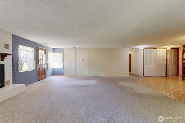 1557 Shelton Rd, Walla Walla, WA 99362 - unfurnished living room with light colored carpet, a large fireplace, and a textured ceiling