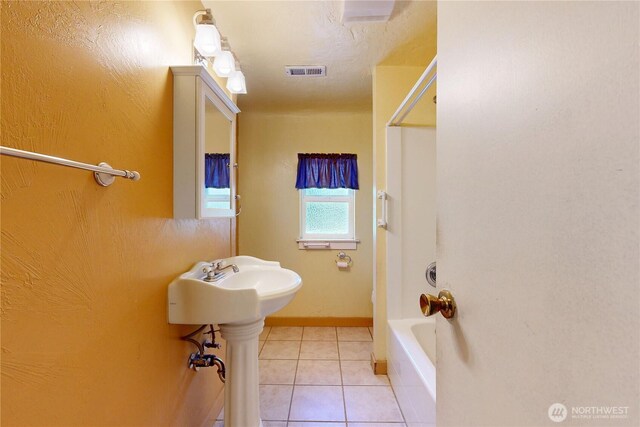 1557 Shelton Rd, Walla Walla, WA 99362 - bathroom featuring tile patterned flooring, tub / shower combination, and baseboards